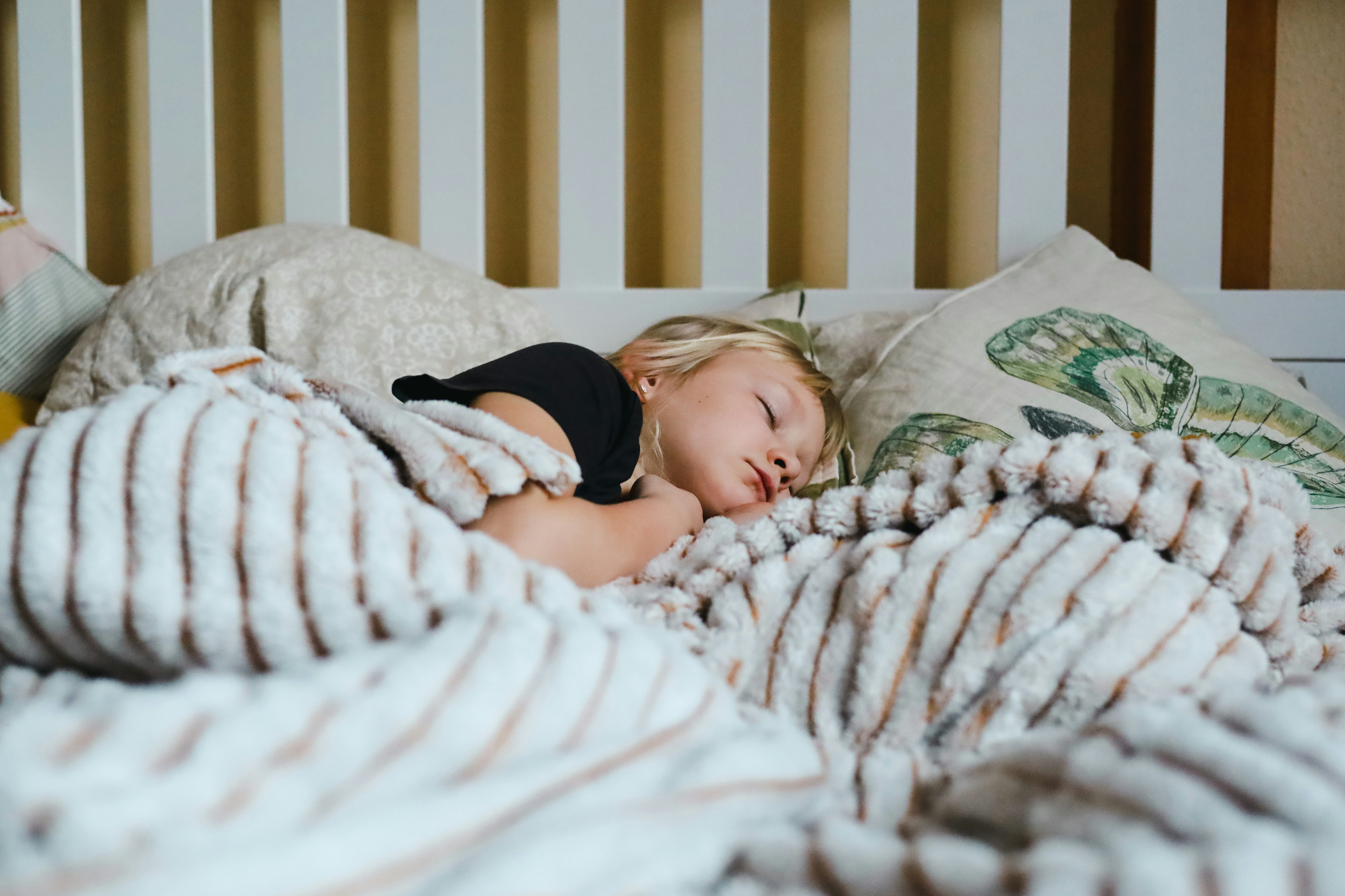 A child sleeping in a big bed